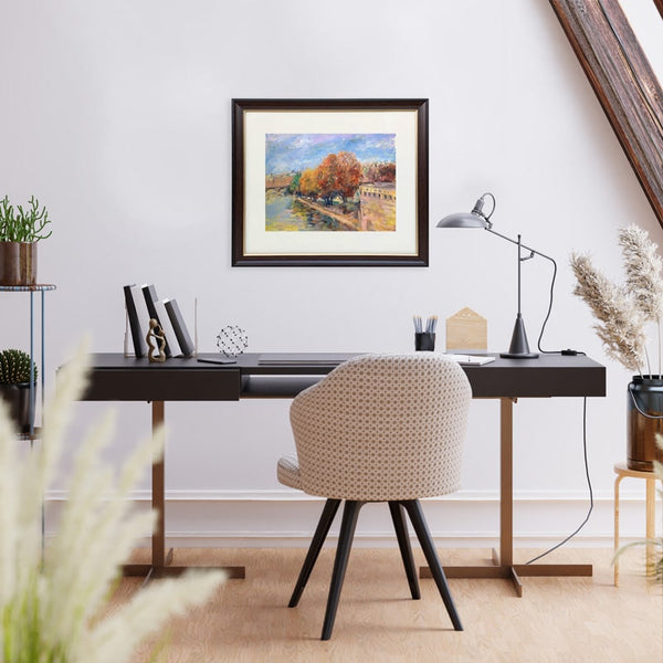ARTualize is the only art gallery in Singapore that lets you rent paintings for your home.  This is an image of a modern study room with a writing desk  and a comfortable chair with a beautiful oil on paper painting of Paris on the wall. 