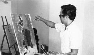 Our artist Low Hai Hong is a Singapore artist. ARTualize is the only art gallery in Singapore that represents him and his works. This is a black and white photo of a young Low Hai Hong. He is standing, painting with a brush in his hand on an oil on canvas