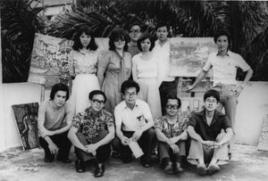 Our artist Low Hai Hong is a Singapore artist. ARTualize is the only art gallery in Singapore that represents him and his works. This is a black and white photo.  A young Low Hai Hong sits on the ground with his friends from the YMCA art club.