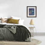 The painting Nightfall at Boat Quay hanging in a bedroom.